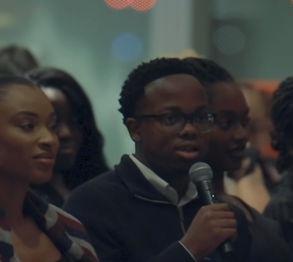Chinonso speaking with a microphone in a crowd